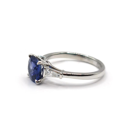 Platinum ring featuring a 1.85 carat blue sapphire and a 0.20 carat diamond accent, elegant jewelry design.