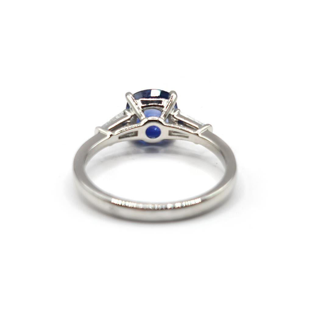 Platinum ring featuring a 1.85 carat blue sapphire center stone accented with 0.20 carat diamonds, elegant jewelry design.