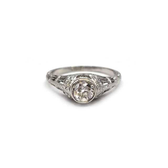 Platinum Art Deco diamond ring with intricate design and sparkling diamonds, showcasing elegant craftsmanship.
