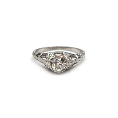 Platinum Art Deco diamond ring with intricate design and sparkling diamonds, showcasing elegant craftsmanship.