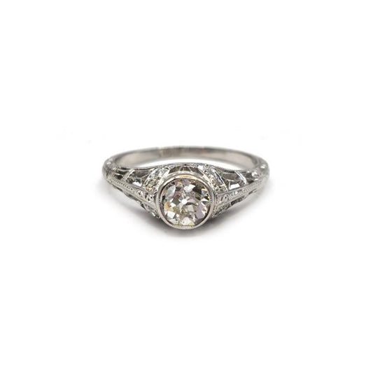 Platinum Art Deco diamond ring with intricate design and sparkling diamonds, showcasing elegant craftsmanship.