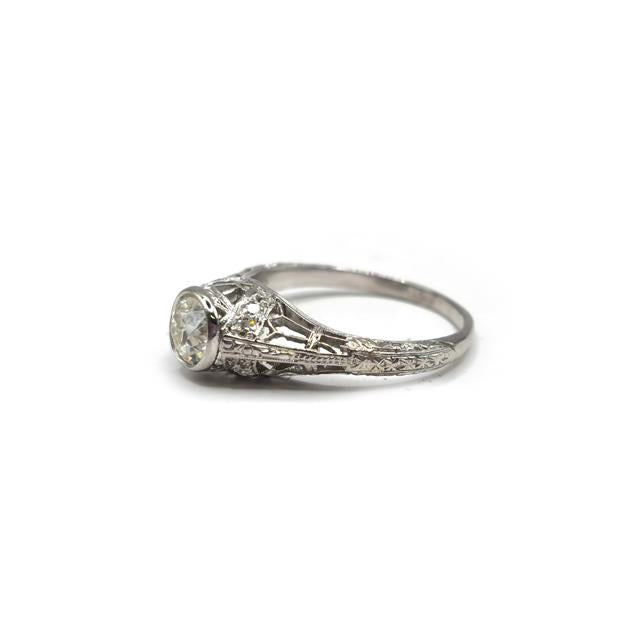 Platinum art deco diamond ring with geometric design and sparkling diamonds, showcasing elegance and intricate craftsmanship.