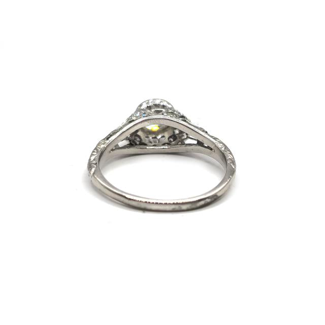 Platinum art deco diamond ring with geometric design and sparkling diamonds, showcasing elegant craftsmanship.