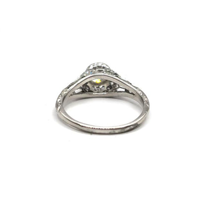 Platinum art deco diamond ring with geometric design and sparkling diamonds, showcasing elegant craftsmanship.