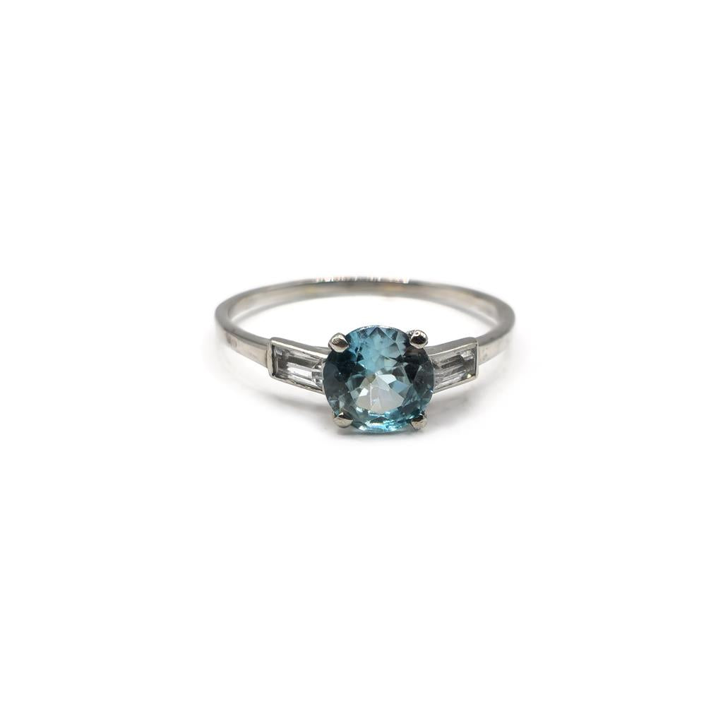 Platinum topaz and cubic zirconia ring featuring a large central gemstone and sparkling side stones, elegant jewelry accessory.