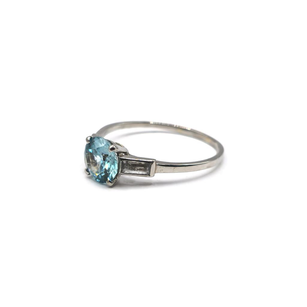 Platinum topaz and cubic zirconia ring with a polished band and sparkling gemstone accents.