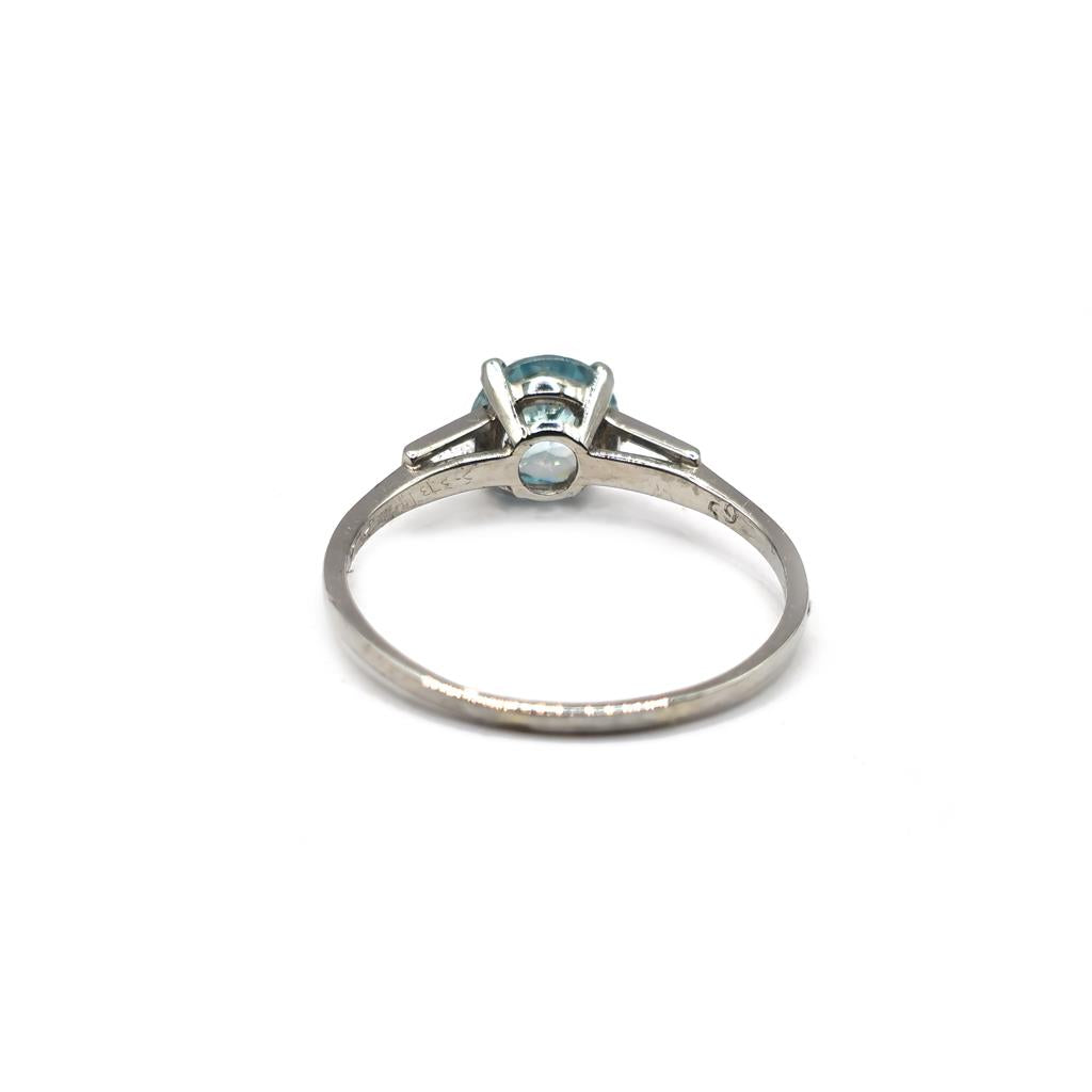 Platinum topaz and cubic zirconia ring featuring a large central gemstone and sparkling accents on a sleek band.