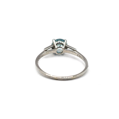 Platinum topaz and cubic zirconia ring featuring a large central gemstone and sparkling accents on a sleek band.
