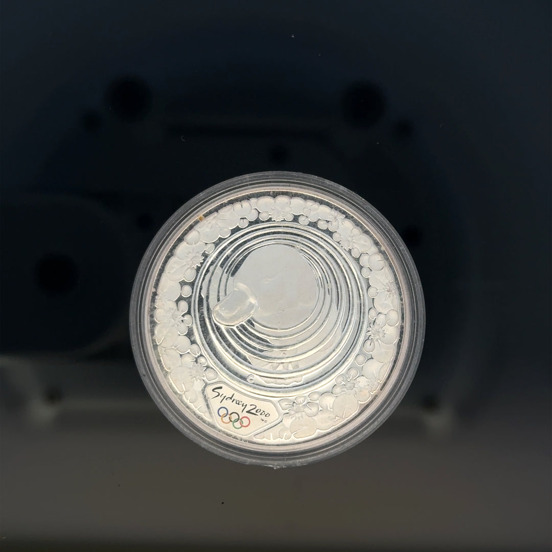 Silver 2000 Olympic coin, 31.4g, featuring Olympic imagery, unbranded collectible coin for enthusiasts.