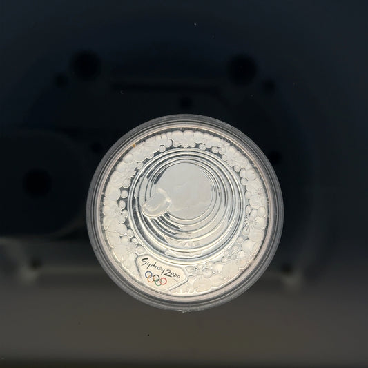 Silver 2000 Olympic coin, 31.4g, featuring Olympic imagery, unbranded collectible coin for enthusiasts.