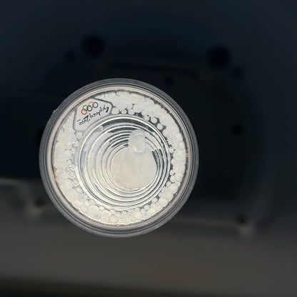 Silver 2000 Olympic coin, 31.4g, featuring Olympic design, unbranded collectible coin with detailed imagery.