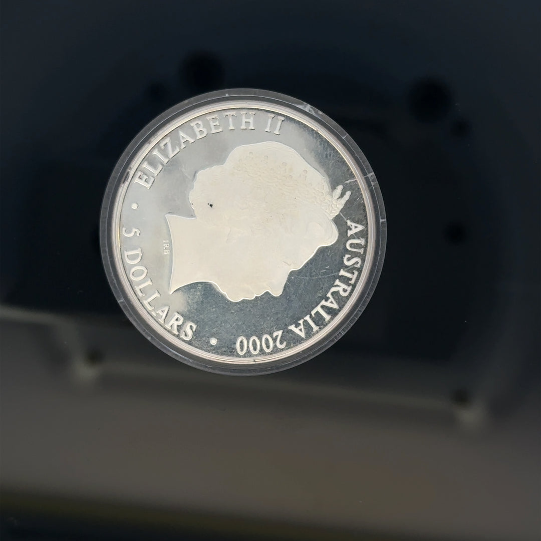 Silver 2000 Olympic coin, 31.4g, featuring Olympic design, unbranded collectible coin with detailed Olympic imagery.