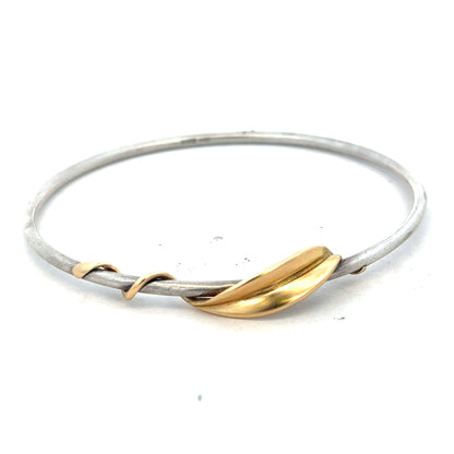 Silver bangle weighing 13.3g, showcased on a neutral background, highlighting its sleek, polished design and elegant craftsmanship.