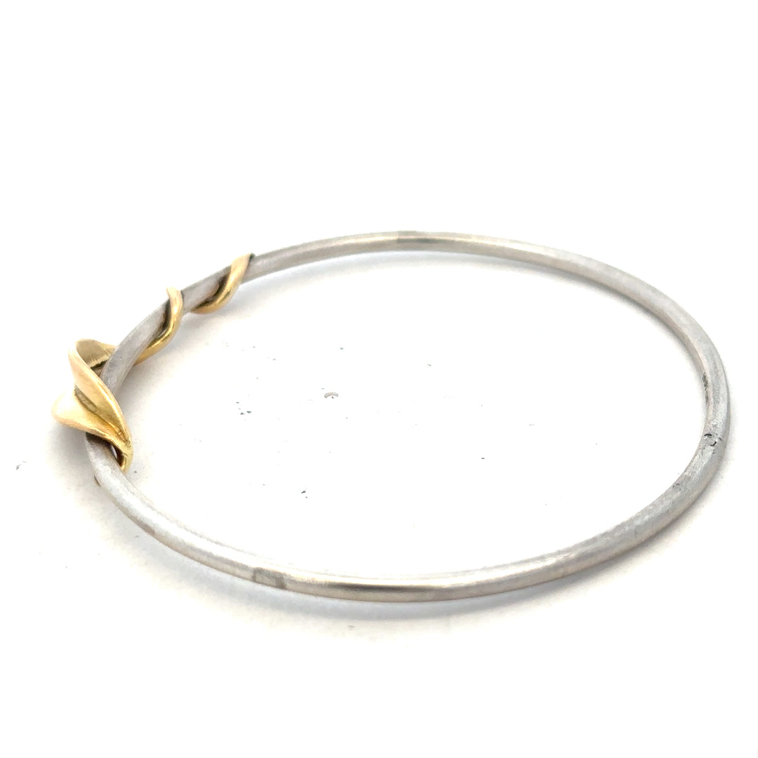 Silver bangle weighing 13.3g, unbranded, featuring a smooth, polished surface and classic design suitable for everyday wear.