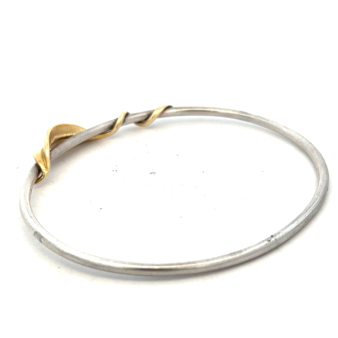 Silver bangle weighing 13.3g, unbranded jewelry piece with a smooth, shiny finish and simple circular design.