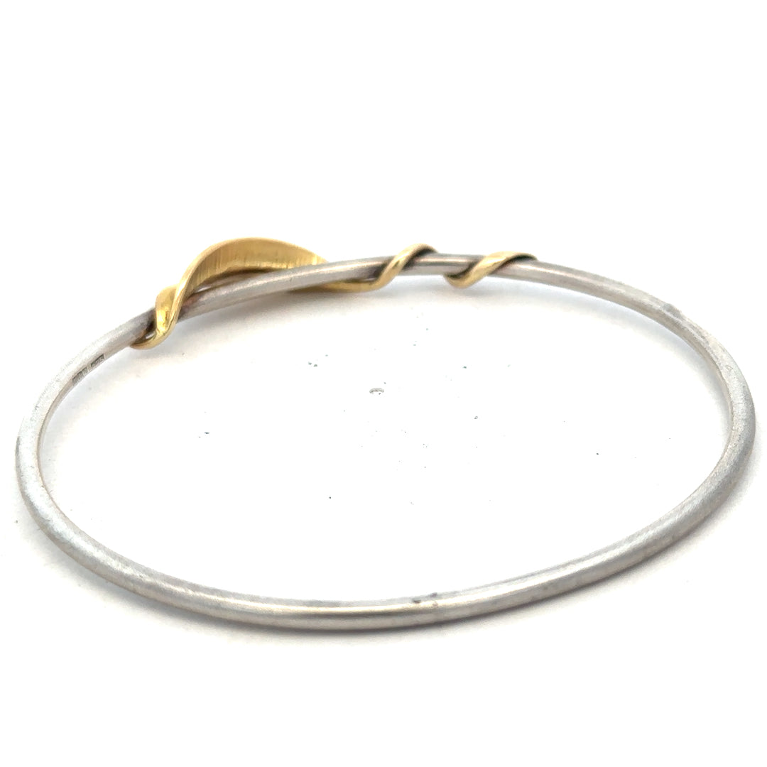 Silver bangle weighing 13.3g with a sleek, polished design, displayed on a neutral background.