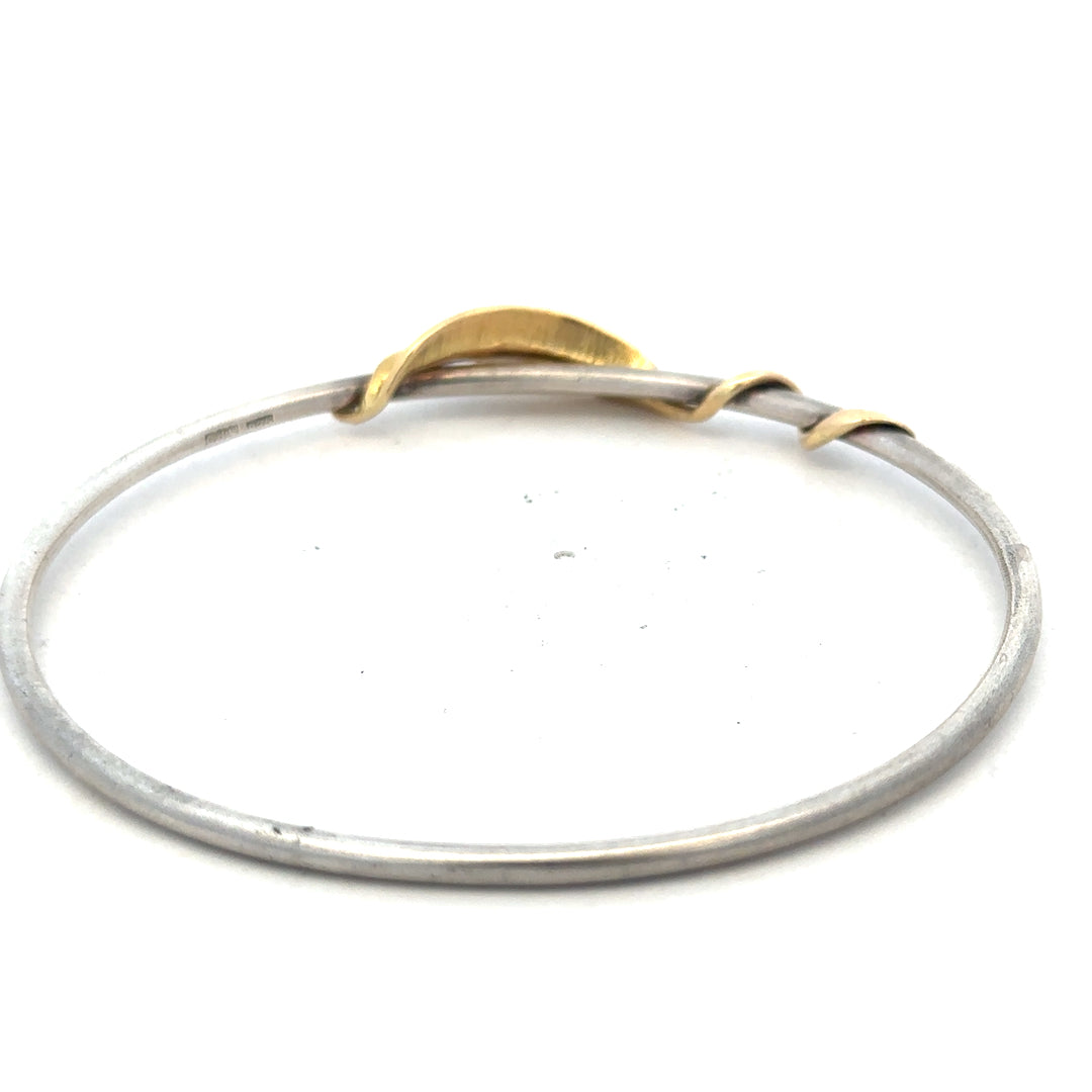 Silver bangle weighing 13.3g with a smooth, polished finish, crafted for elegant jewelry wear.