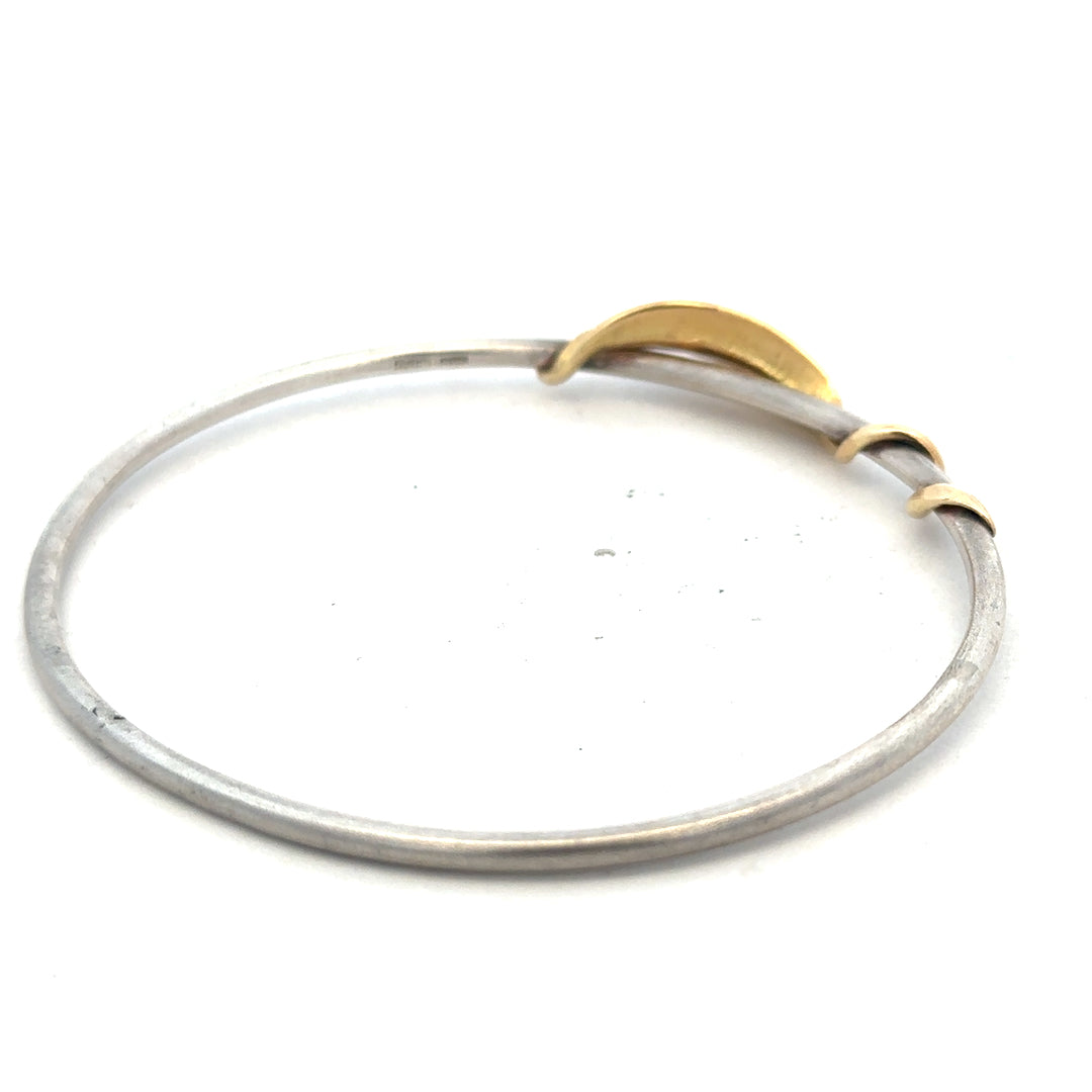 Silver bangle weighing 13.3g, featuring a smooth, polished finish, designed for elegant wrist jewelry.
