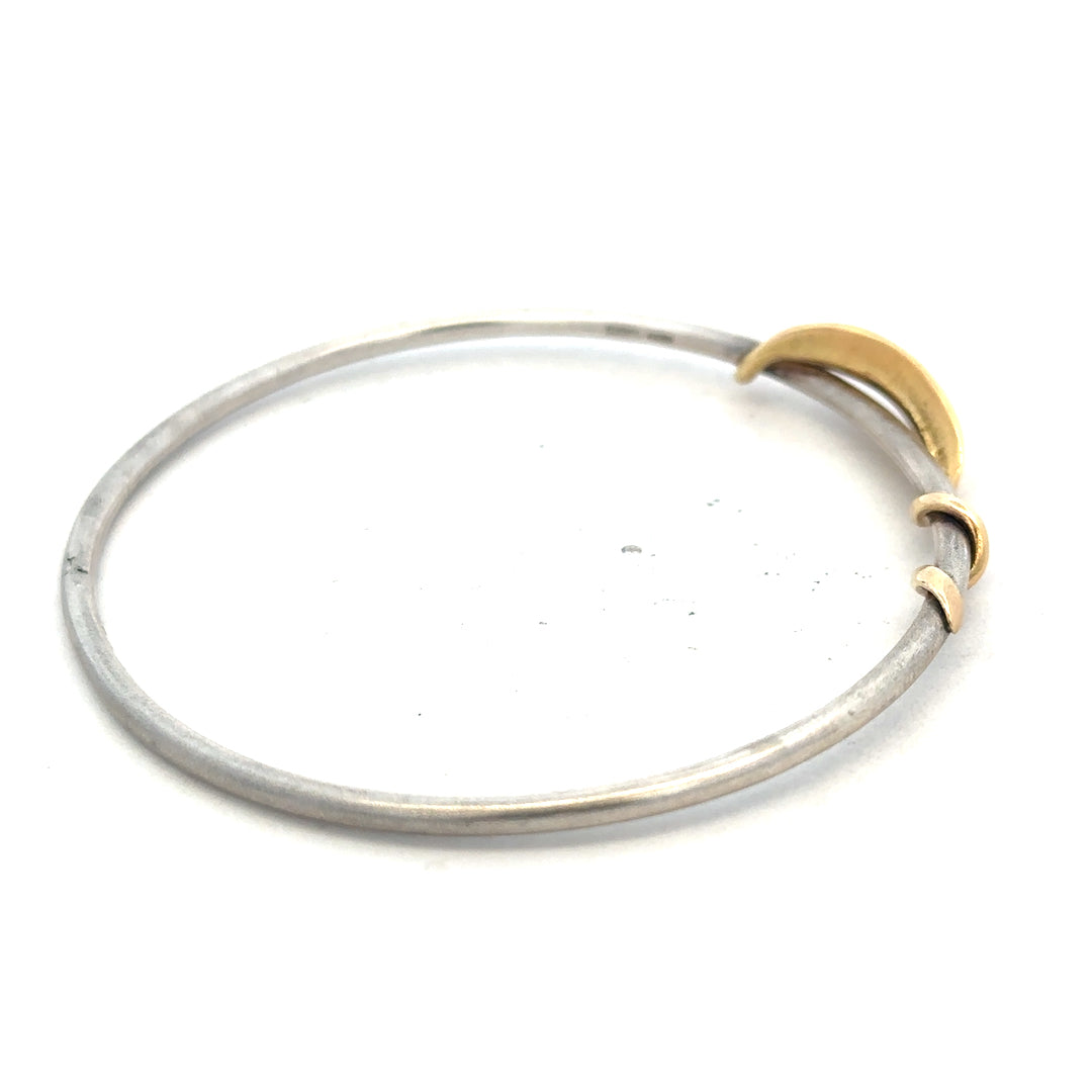 Silver bangle weighing 13.3g with a smooth, polished finish, designed for elegant wristwear.