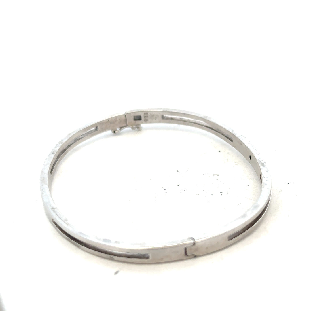 Silver bangle weighing 13.5g with a sleek, polished finish, designed for elegant wrist wear.
