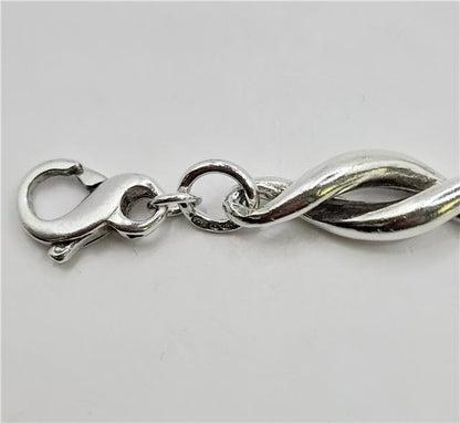 Silver bracelet 19cm, 14.4g, unbranded, with a smooth, polished finish and intricate detailing visible in the image.