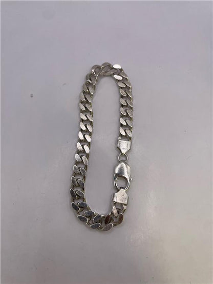 Silver bracelet weighing 33.8g with intricate designs, crafted from unbranded metal, displayed on a neutral background.