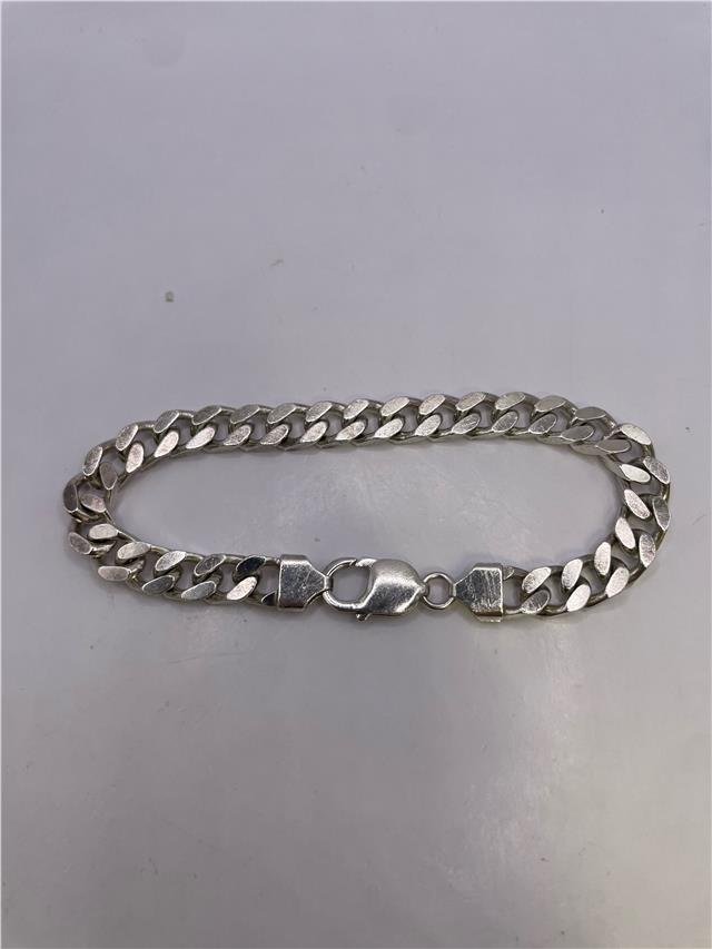 Silver bracelet weighing 33.8g with intricate design, showcasing a sleek and polished appearance, perfect for stylish accessories.