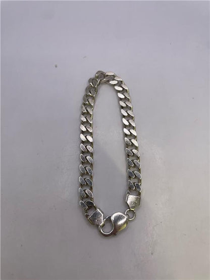 Silver bracelet weighing 33.8g with intricate design, crafted for stylish wear, unbranded jewelry accessory.