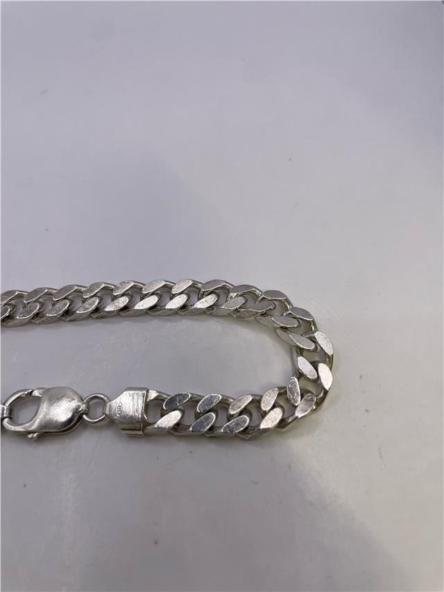 Silver bracelet weighing 33.8g with a sleek design, perfect for stylish accessories and everyday wear.