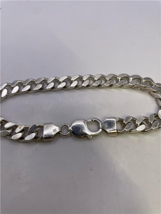 Silver bracelet weighing 33.8g with intricate design, featuring a sleek and polished finish, ideal for stylish accessories.