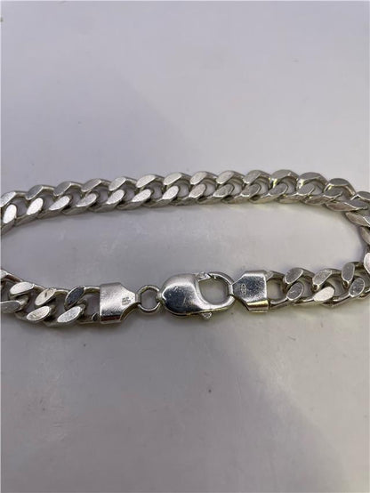 Silver bracelet weighing 33.8g with intricate design, featuring a sleek and polished finish, ideal for stylish accessories.