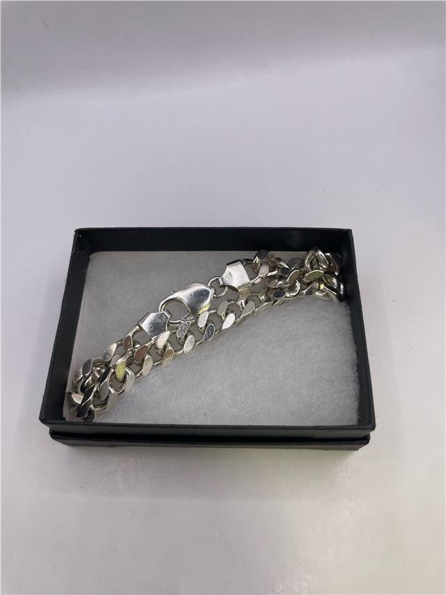 Silver bracelet weighing 33.8g with intricate design, featuring a sleek and polished finish, perfect for stylish accessorizing.