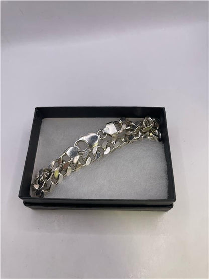 Silver bracelet weighing 33.8g with a sleek design, featuring a polished finish and intricate details.