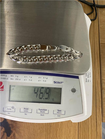 Silver bracelet weighing 47g with intricate design, unbranded, shown on a neutral background.