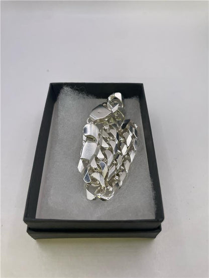 Silver bracelet weighing 47 grams with a sleek design, featuring a polished finish and intricate detailing.