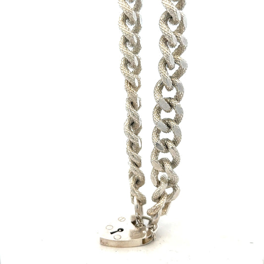 Silver bracelet weighing 64.4g with intricate design, unbranded jewelry piece shown on a neutral background