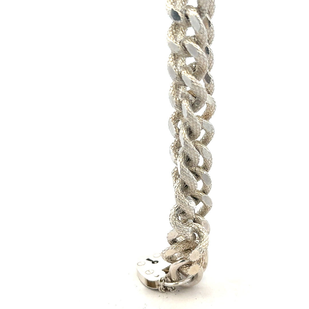 Silver bracelet weighing 64.4g with intricate design, unbranded jewelry accessory visible in the image.