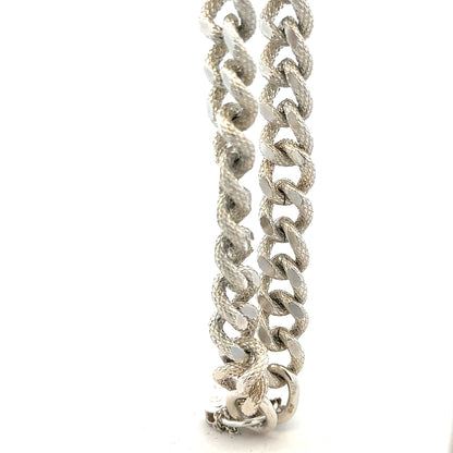 Silver bracelet weighing 64.4g with a sleek design, featuring a shiny finish and intricate details on a neutral background.