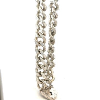 Silver bracelet weighing 64.4g with intricate design, unbranded jewelry piece displayed on a plain background.