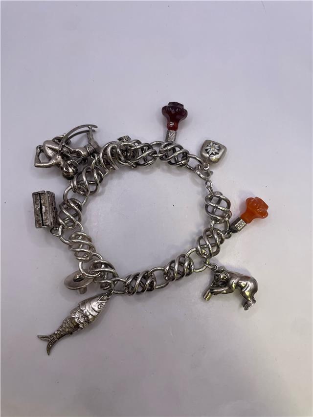 Silver bracelet weighing 73.5 grams with intricate design, showcased in a clear image highlighting its shiny surface and craftsmanship.