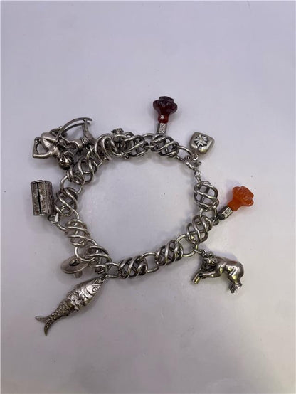 Silver bracelet weighing 73.5 grams with intricate design, showcased in a clear image highlighting its shiny surface and craftsmanship.