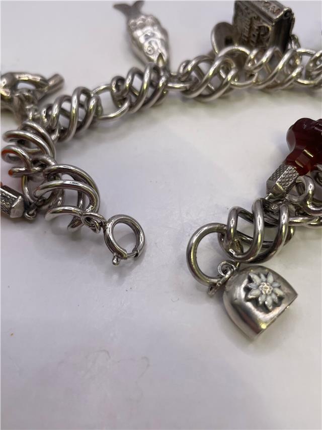 Silver bracelet weighing 73.5 grams with a sleek design, featuring a shiny finish and intricate detailing.