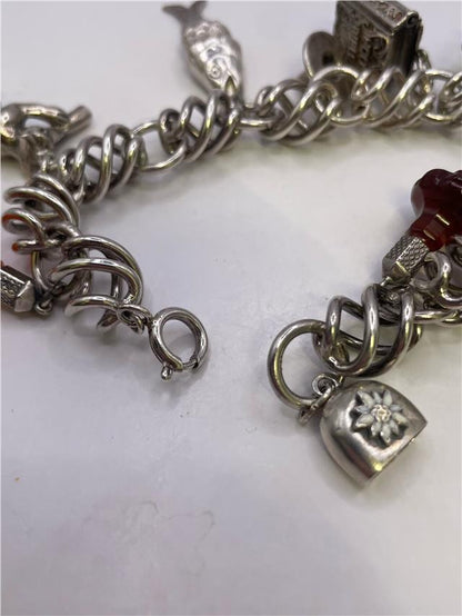 Silver bracelet weighing 73.5 grams with a sleek design, featuring a shiny finish and intricate detailing.