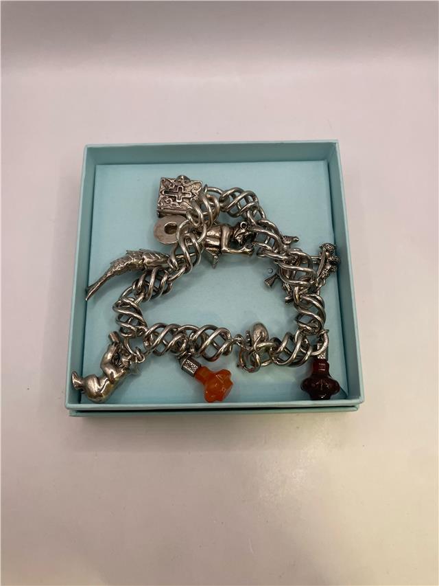 Silver bracelet weighing 73.5 grams with intricate design, featuring polished silver links and a secure clasp.