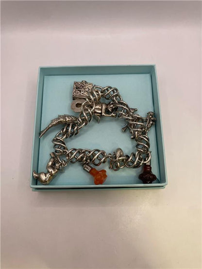 Silver bracelet weighing 73.5 grams with intricate design, featuring polished silver links and a secure clasp.