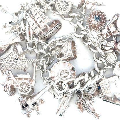 Silver charm bracelet weighing 154.4g with intricate charms and links, unbranded jewelry accessory for stylish wear.