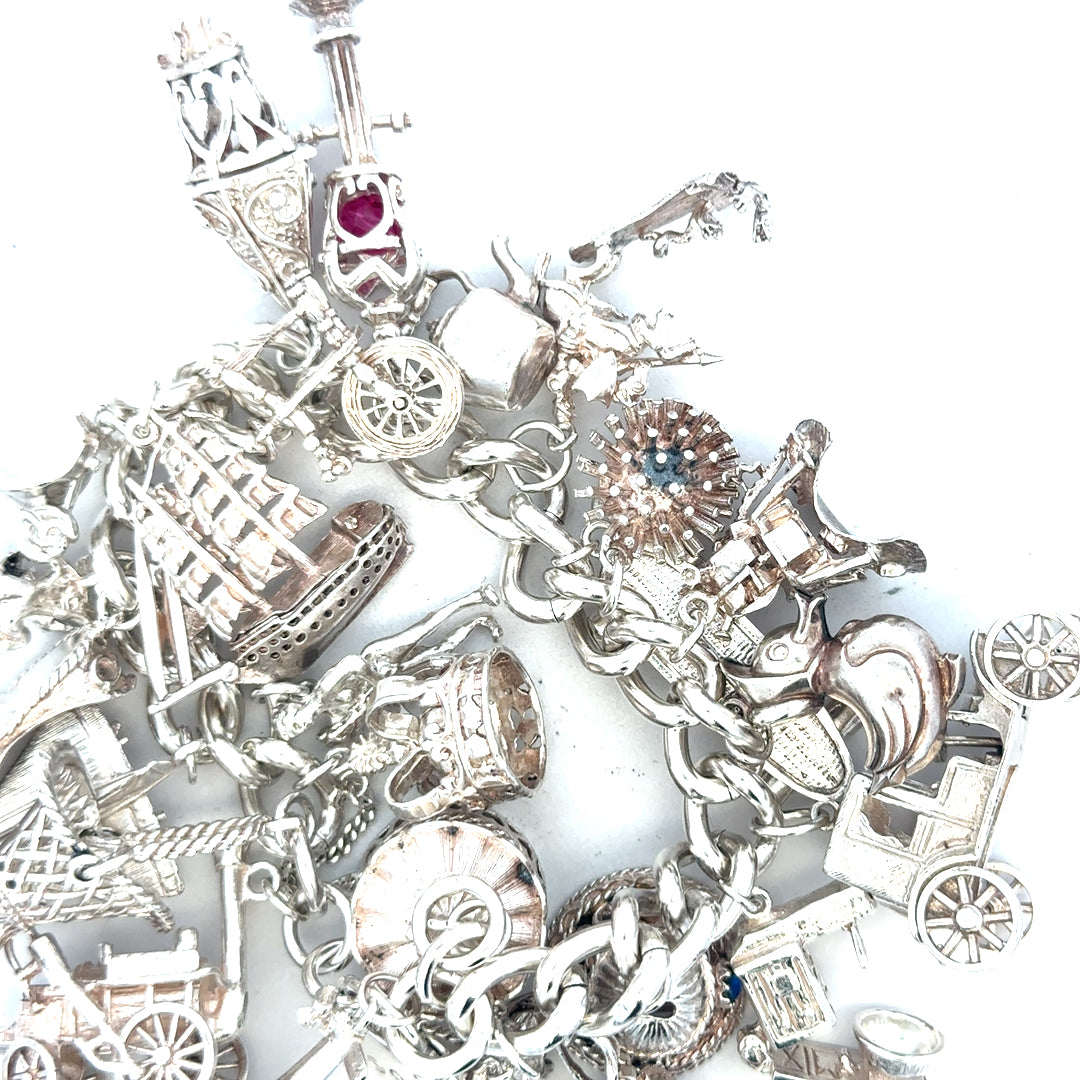Silver charm bracelet weighing 154.4g with intricate charms, crafted for stylish accessories and everyday wear.