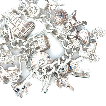 Silver charm bracelet weighing 154.4g with various charms, unbranded jewelry accessory, detailed close-up of the bracelet.