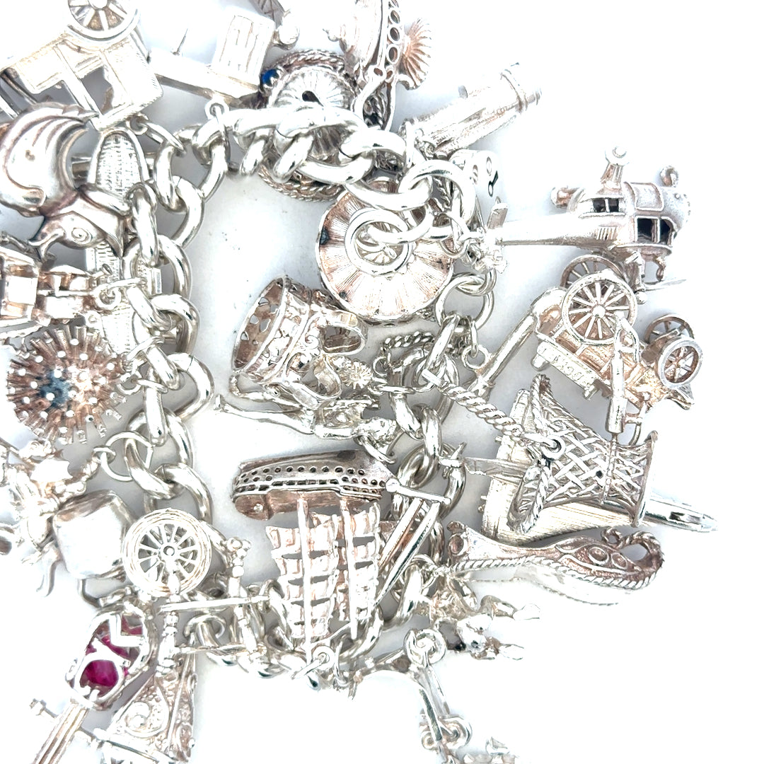 Silver charm bracelet weighing 154.4g with intricate charms, crafted for a stylish and elegant look.