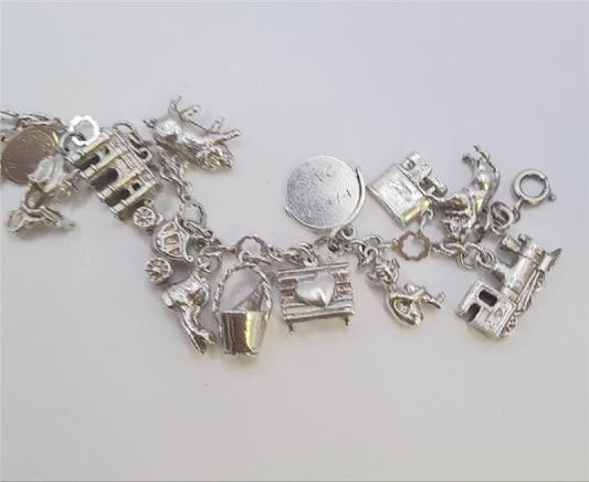 Silver charm bracelet weighing 45.9g with various decorative charms, crafted from high-quality silver.